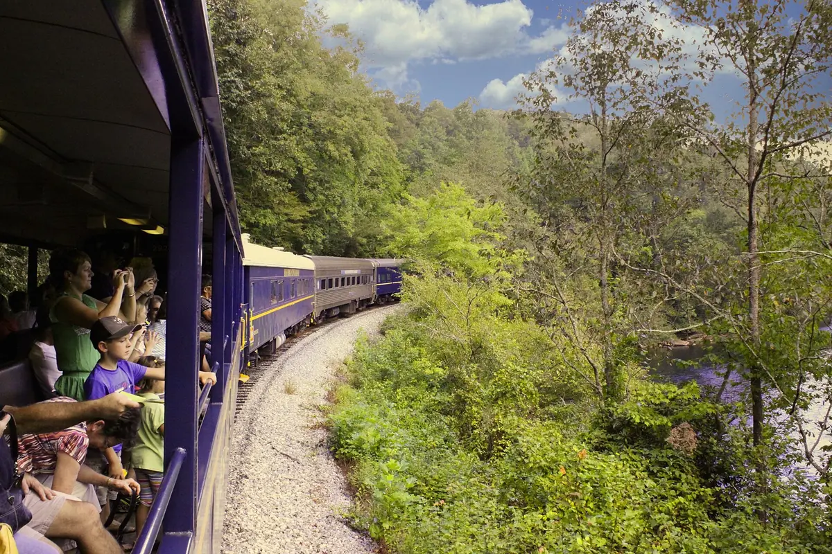 Riders on the Blue Ridge Scenic Railway with green hills alongside
