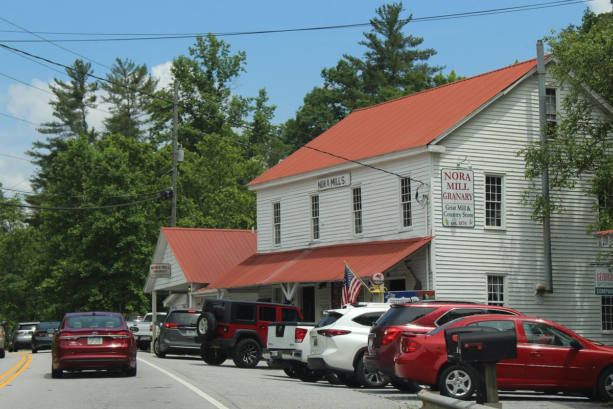 The white clapboard Nora Mill Granary building with a red roof beside the highway