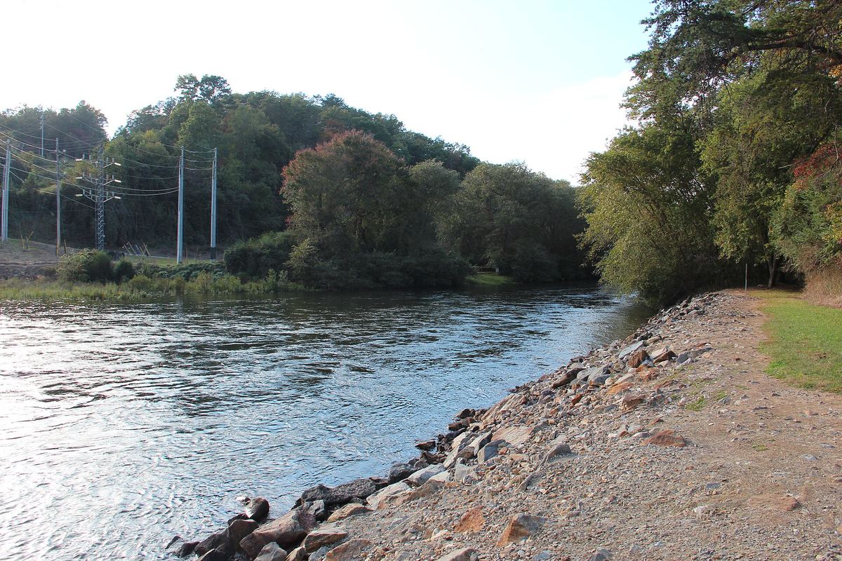 The Toccoa River flowing past a rocky bank on a sunny day