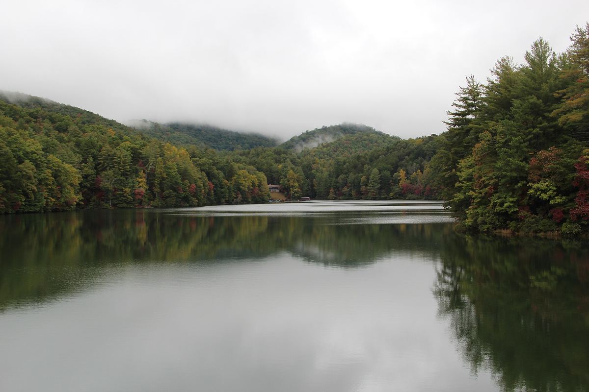Unicoi Lake on an overcast October day, with wooded mountains reflected in the water